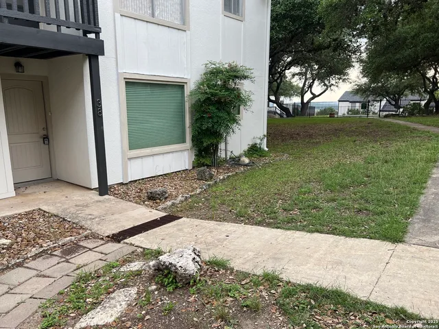 a view of a backyard of the house