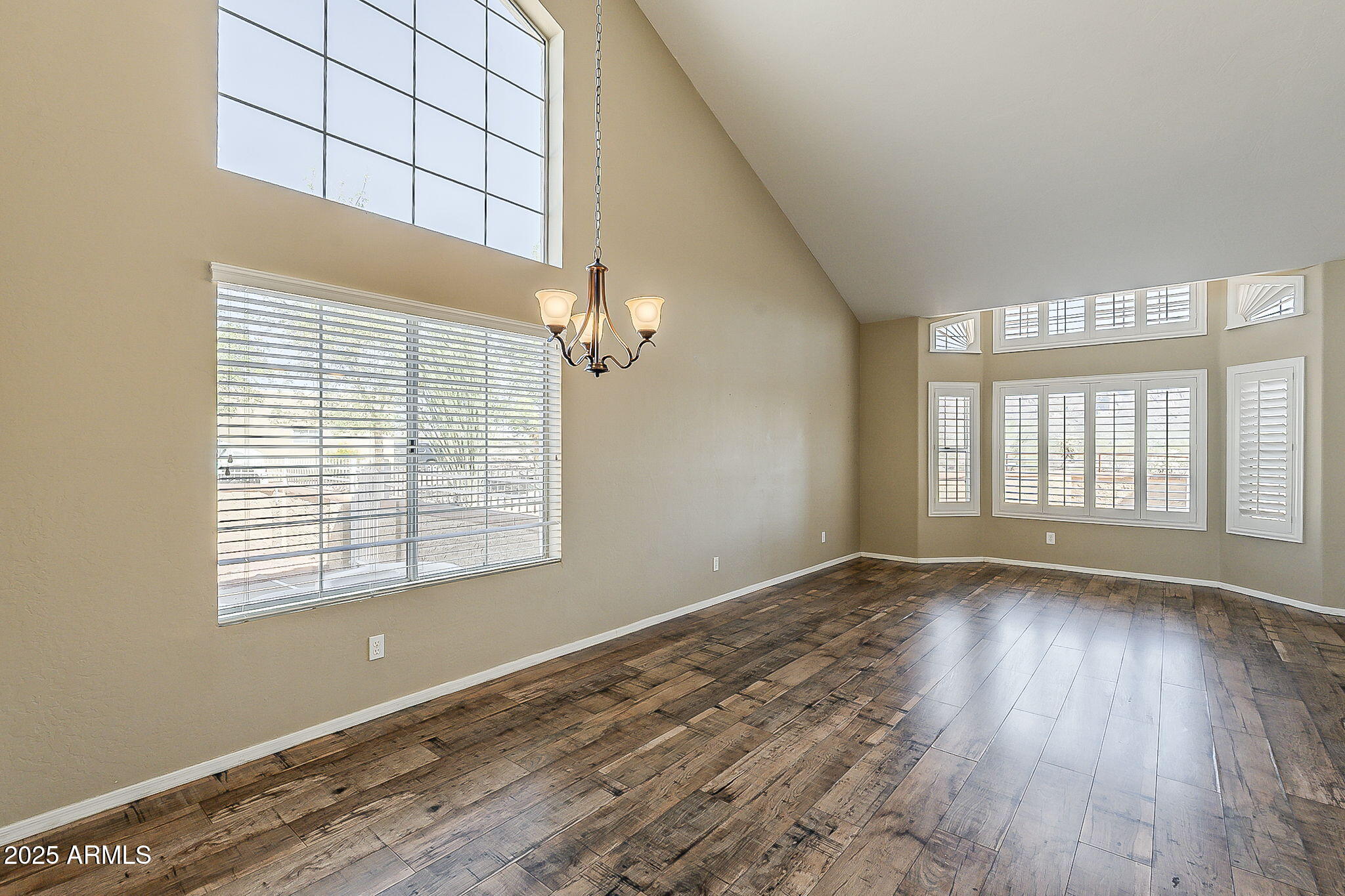 1410 North Goldfield Road Apache Junction, AZ 85119 - Photo 17 of 45 a view of an empty room with wooden floor and a window