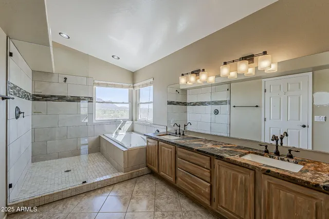 a spacious bathroom with a shower sink mirror and
