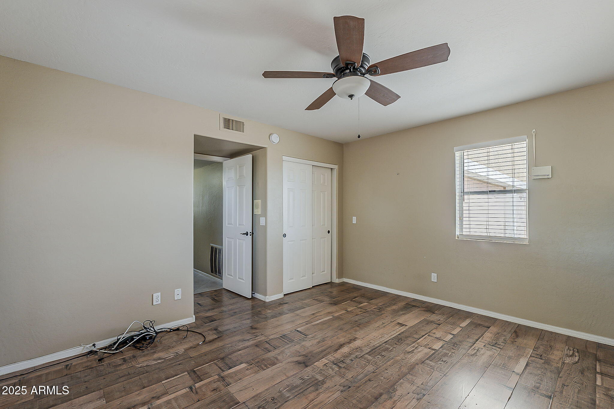 1410 North Goldfield Road Apache Junction, AZ 85119 - Photo 24 of 45 a view of a room with a wooden floor and ceiling fan