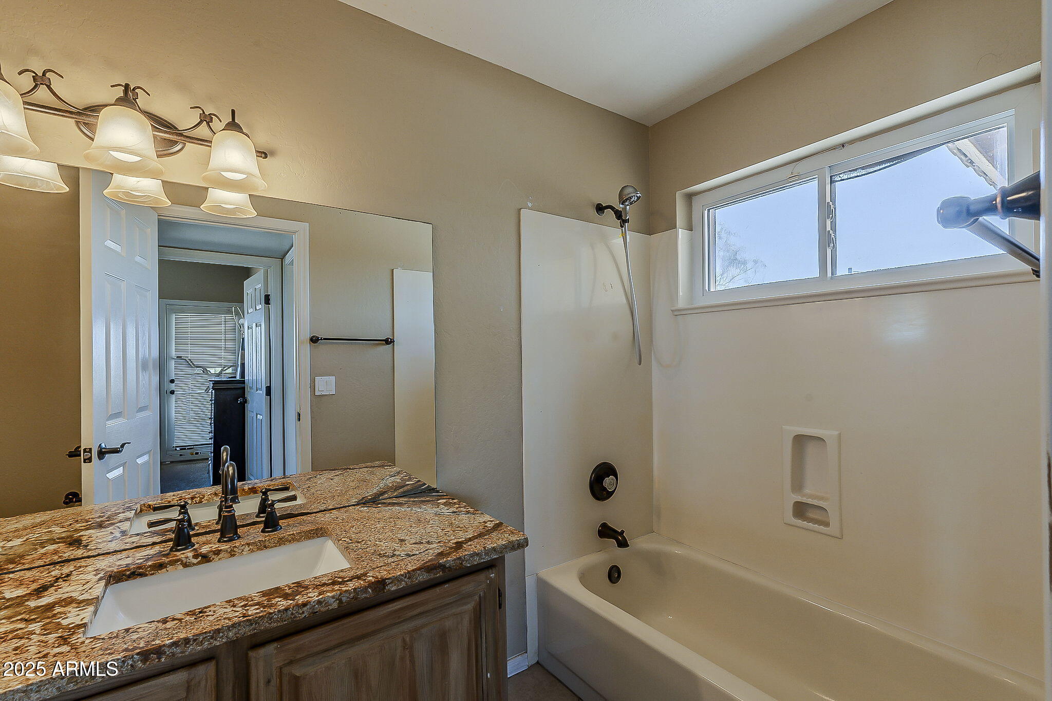 1410 North Goldfield Road Apache Junction, AZ 85119 - Photo 25 of 45 a bathroom with a granite countertop sink and a mirror
