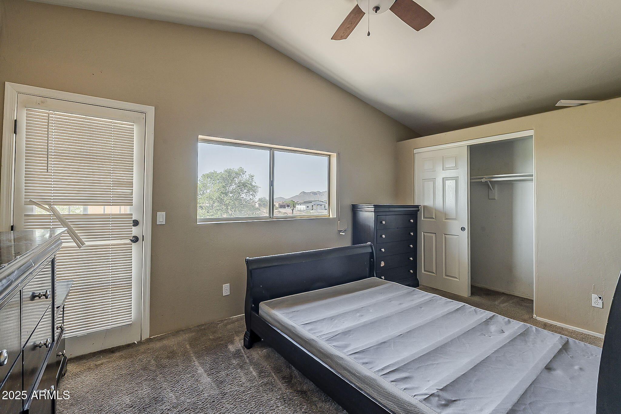 1410 North Goldfield Road Apache Junction, AZ 85119 - Photo 26 of 45 a bed sitting in a bedroom next to a window