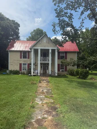 a front view of a house with a garden