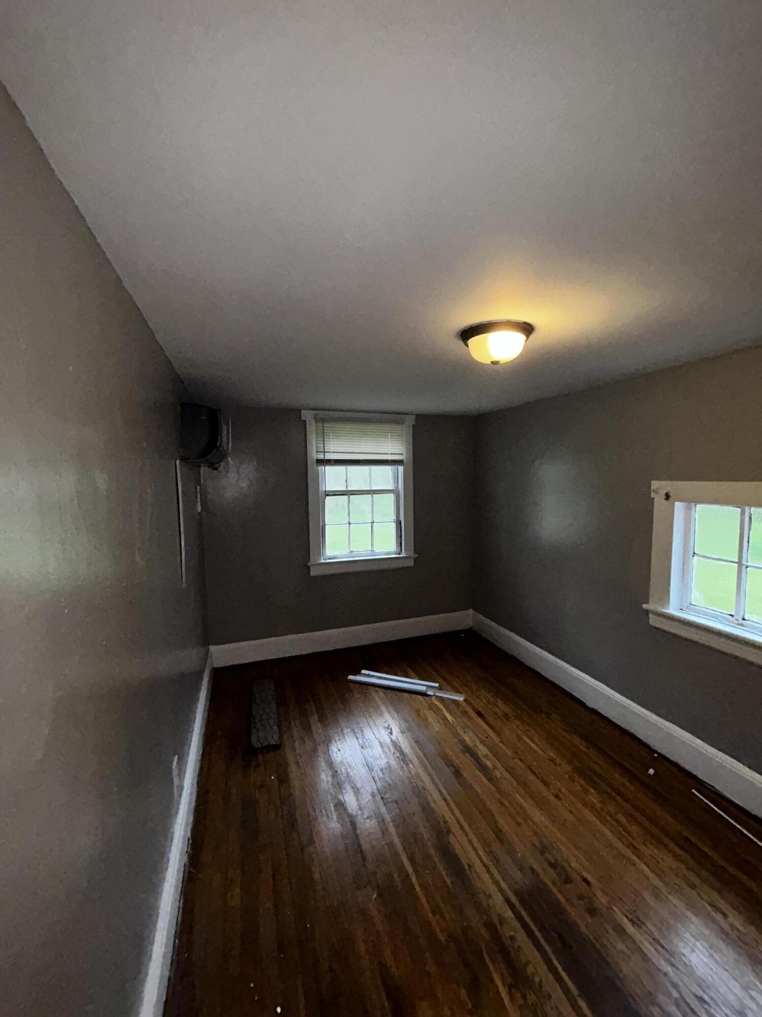 579-581 Botetourt Road Fincastle, VA 24090 - Photo 11 of 30 an empty room with wooden floor and windows