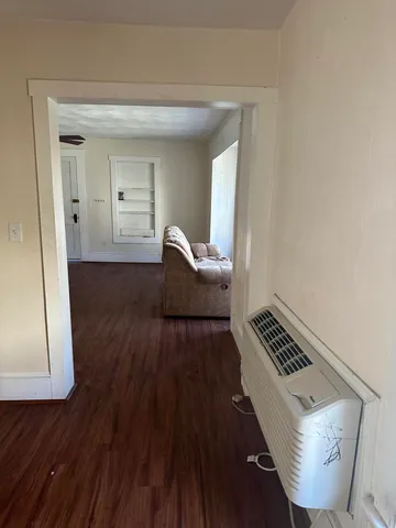a view of living room and wooden floor