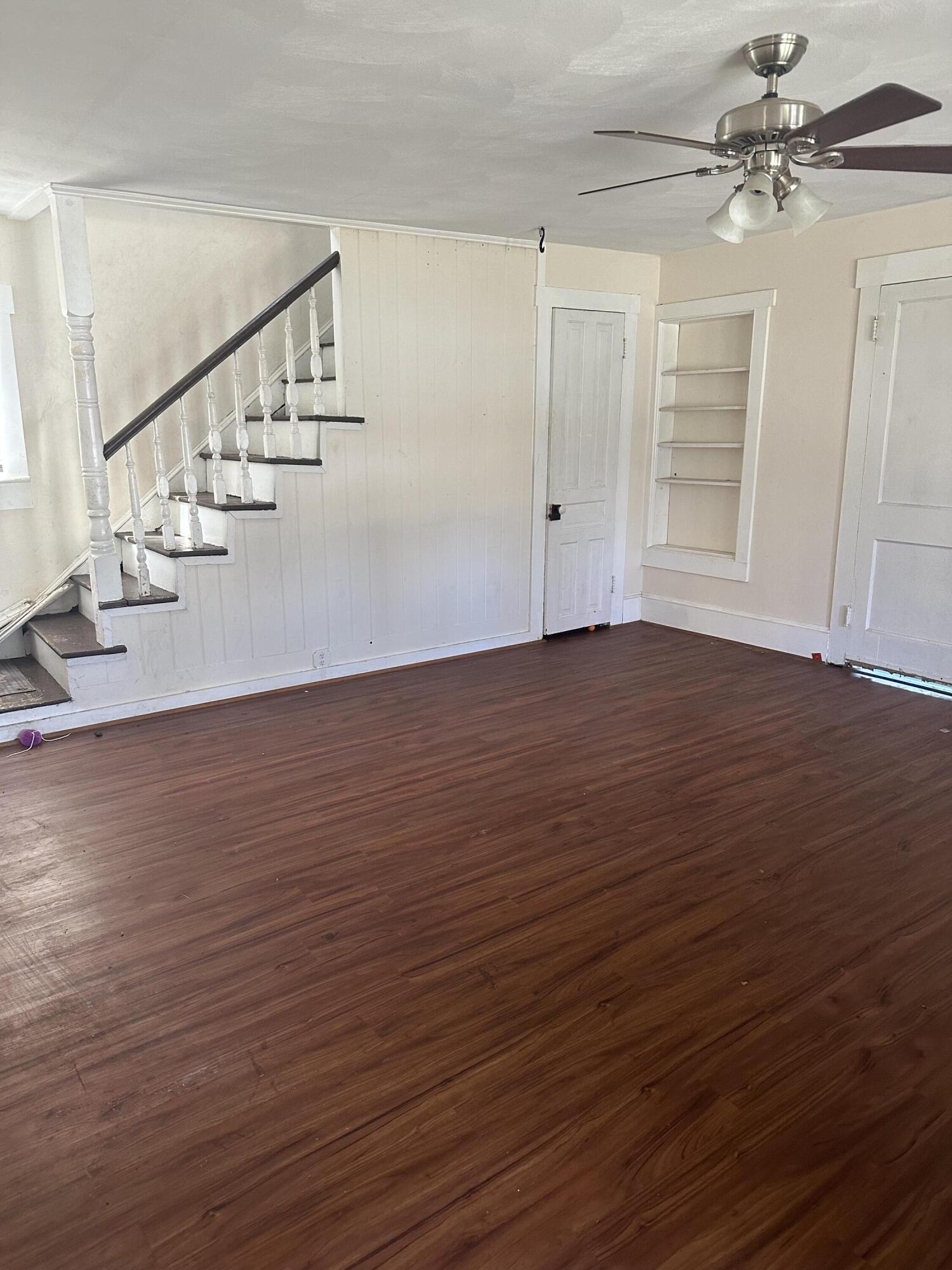 579-581 Botetourt Road Fincastle, VA 24090 - Photo 13 of 30 a view of an empty room with wooden floor and stairs