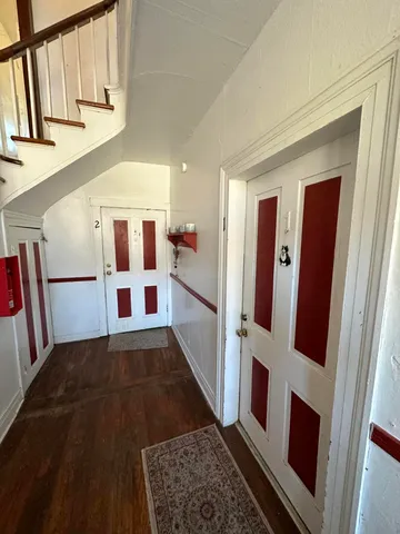 a view of entryway with furniture and wooden floor