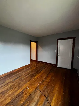 a view of an empty room and wooden floor