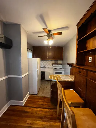 a kitchen with stainless steel appliances a stove a refrigerator and a fireplace