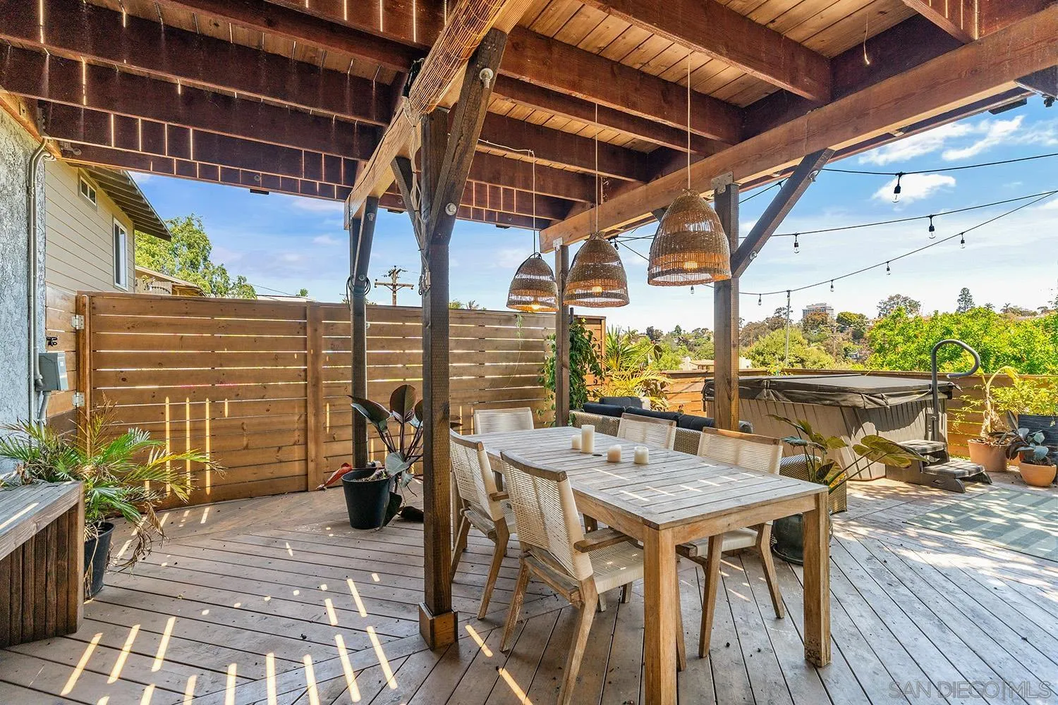 3109 Hawk Street San Diego, CA 92103 - Photo 1 of 75 a roof deck with table and chairs and wooden floor