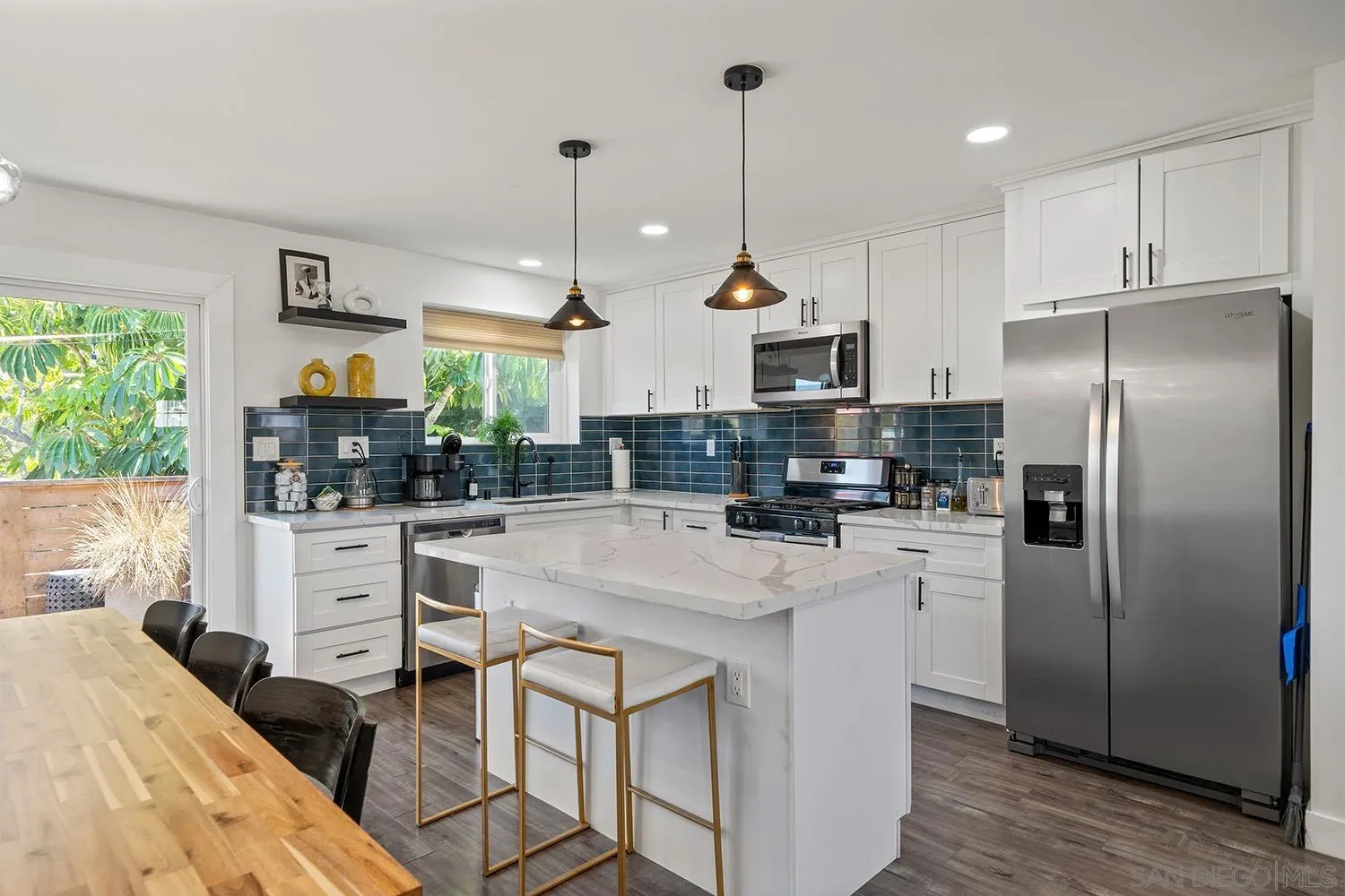 3109 Hawk Street San Diego, CA 92103 - Photo 4 of 75 a kitchen with white cabinets and stainless steel appliances