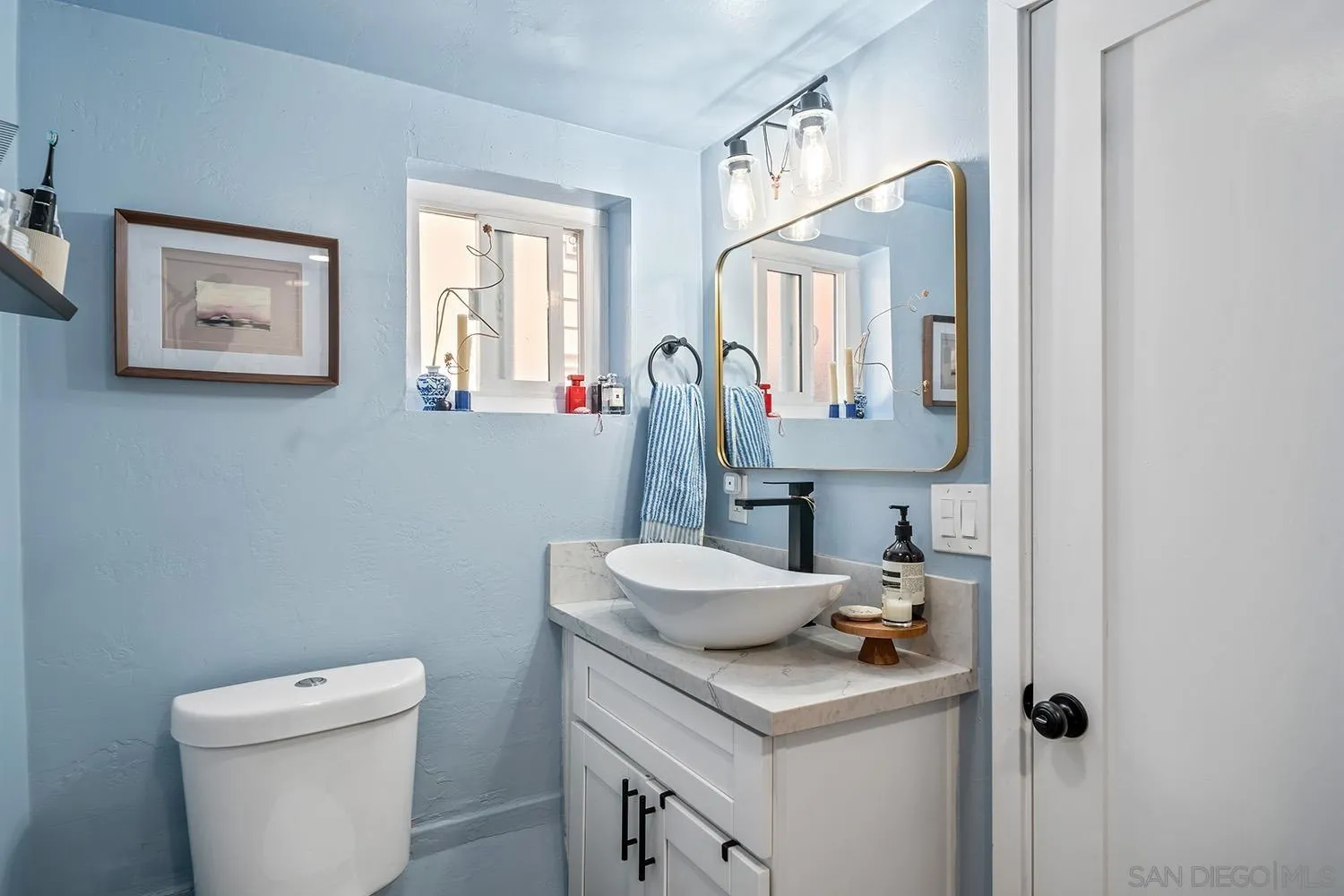 3109 Hawk Street San Diego, CA 92103 - Photo 70 of 75 a bathroom with a toilet sink and mirror