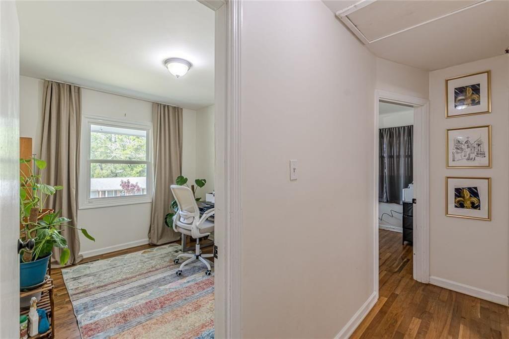 4558 Ryan Road Conley, GA 30288 - Photo 17 of 34 a hallway with wooden floor windows and painted walls