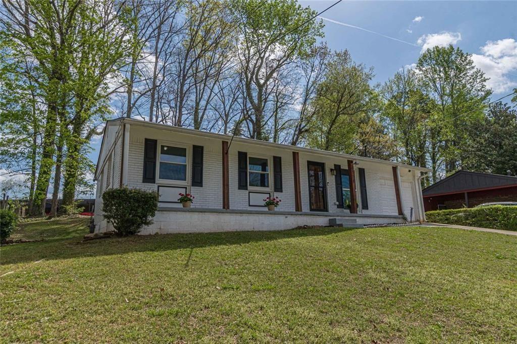 4558 Ryan Road Conley, GA 30288 - Photo 2 of 34 a front view of house with yard and green space