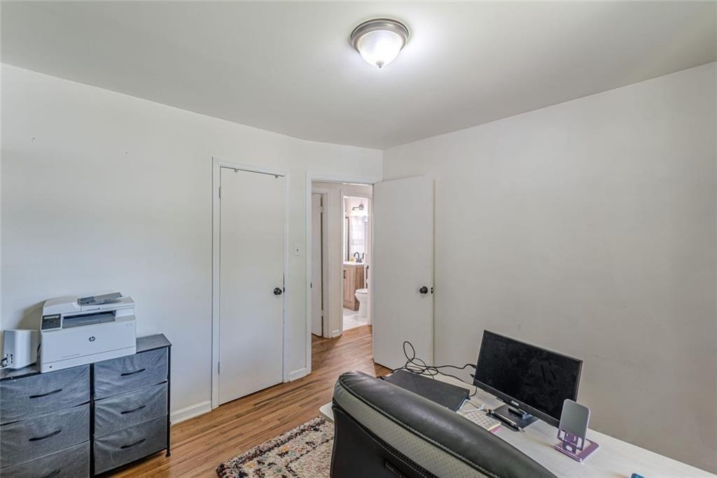 4558 Ryan Road Conley, GA 30288 - Photo 24 of 34 a bedroom with a bed and wooden floor