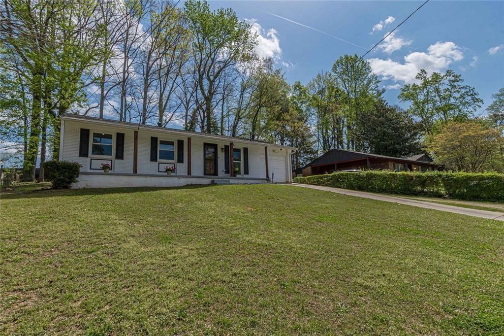 4558 Ryan Road Conley, GA 30288 - Photo 3 of 34 a front view of house with yard and green space