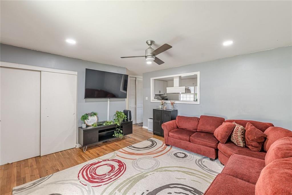 4558 Ryan Road Conley, GA 30288 - Photo 7 of 34 a living room with furniture a flat screen tv and kitchen view