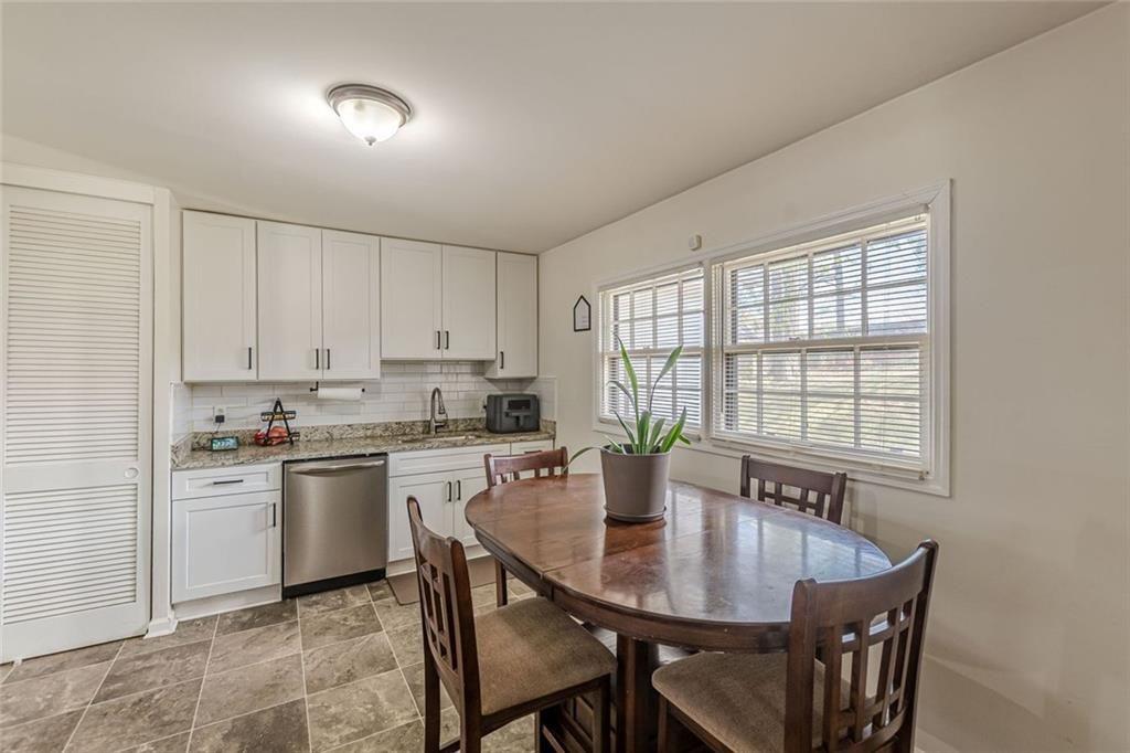 4558 Ryan Road Conley, GA 30288 - Photo 10 of 34 a kitchen with a table chairs sink and cabinets
