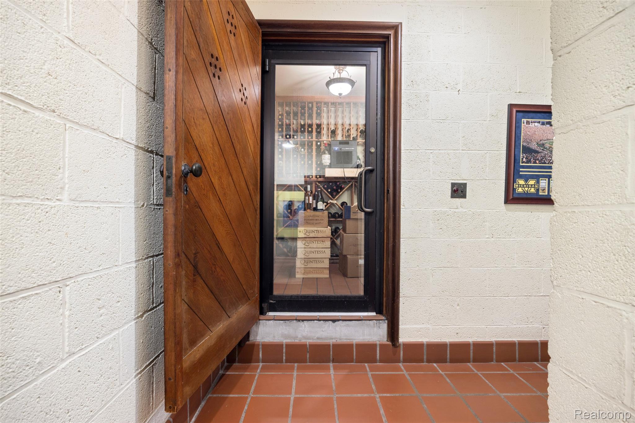 189 Cloverly Road Grosse Pointe, MI 48236 - Photo 64 of 93 A substantial wood door opens to a professionally climate-controlled wine cellar, thoughtfully designed for serious collectors and effortless entertaining.