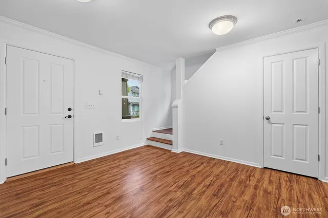 wooden floor in an empty room with a window