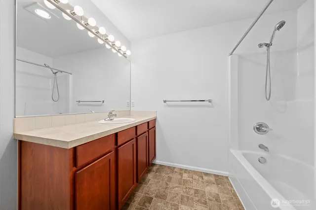 a bathroom with a double vanity sink and a mirror