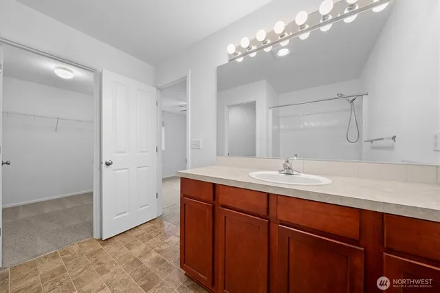 a bedroom with a bed a chandelier and a potted plant