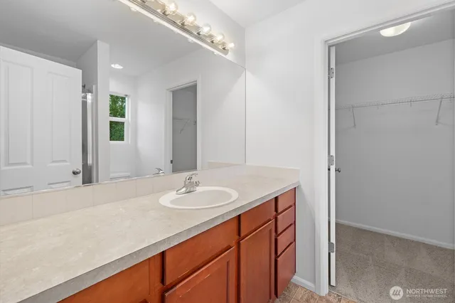 a bathroom with a sink double vanity and a mirror
