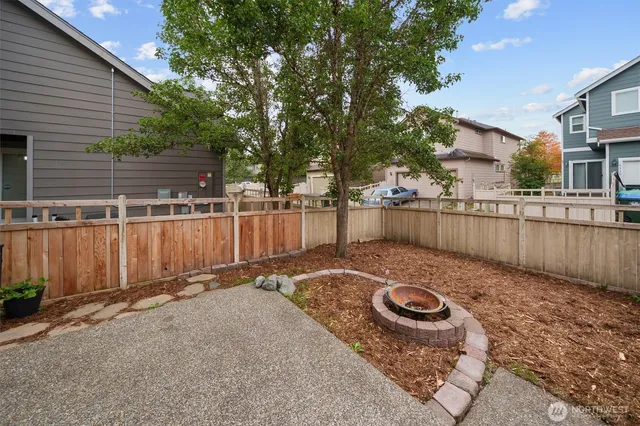 a view of a backyard with a small cabin and a chair