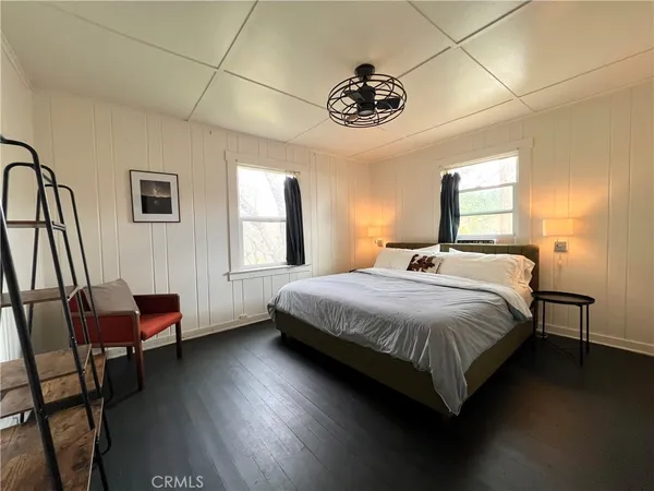 a bedroom with a bed and a chair