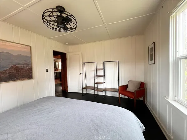 a bedroom with a bed and a large window