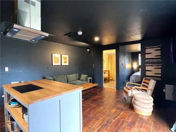 a room with wooden floor and furniture