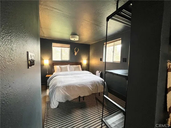 a bedroom with a bed and a mirror
