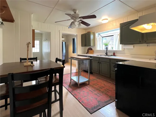 a kitchen with stainless steel appliances granite countertop a dining table and chairs