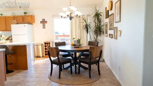 a dining room with furniture and a chandelier