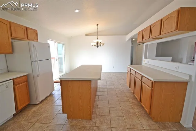 a kitchen with stainless steel appliances a refrigerator and a stove top oven