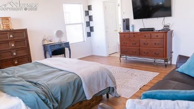 a bedroom with a bed and flat screen tv