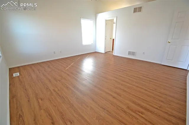 wooden floor in a hall with an empty room