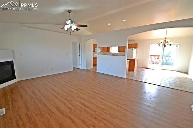 a view of a room with kitchen and chandelier