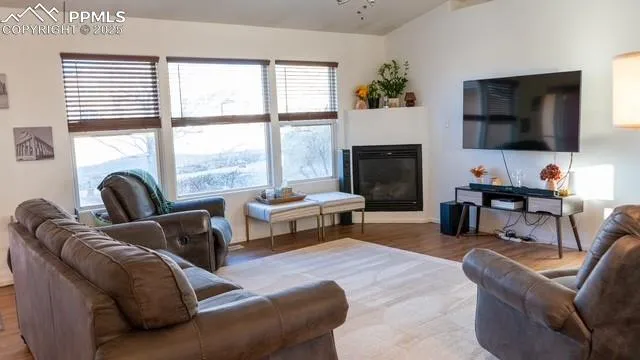 a living room with furniture fireplace and flat screen tv