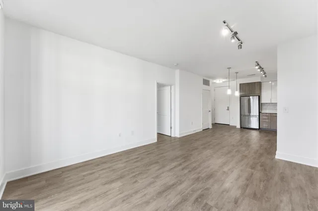 a view of a kitchen with a refrigerator and a window
