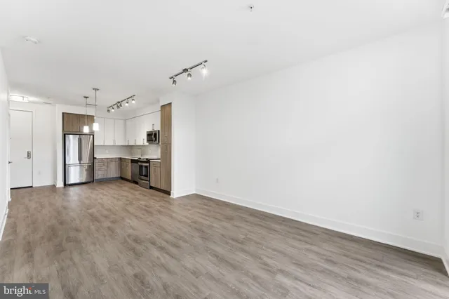a view of a kitchen with a sink and a refrigerator