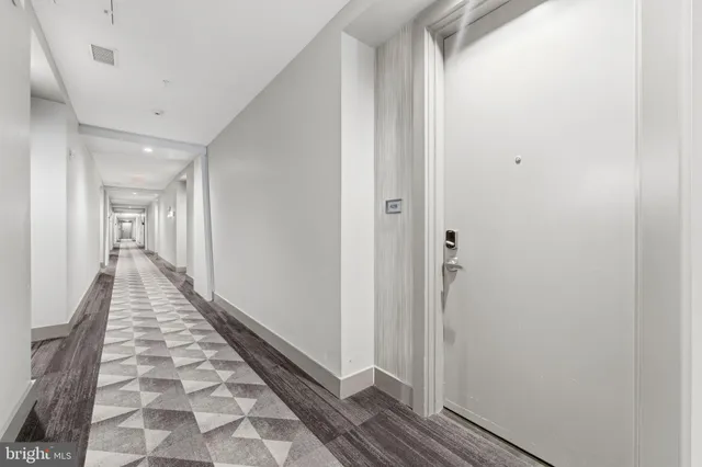 a view of hallway with wooden floor