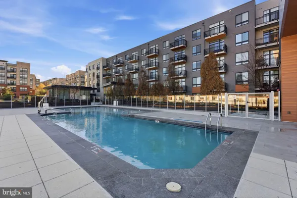 a view of swimming pool with outdoor seating and city view
