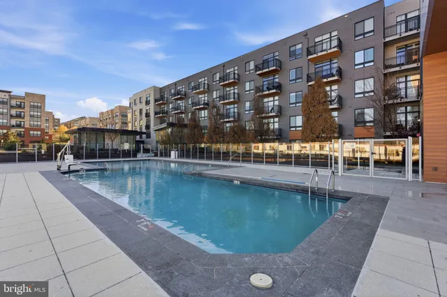 a view of swimming pool with outdoor seating and city view