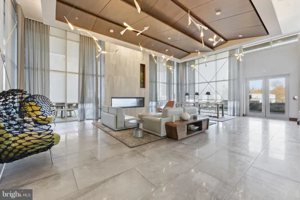 a lobby with furniture and a chandelier