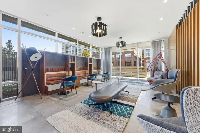 a living room with furniture a window and gym equipment
