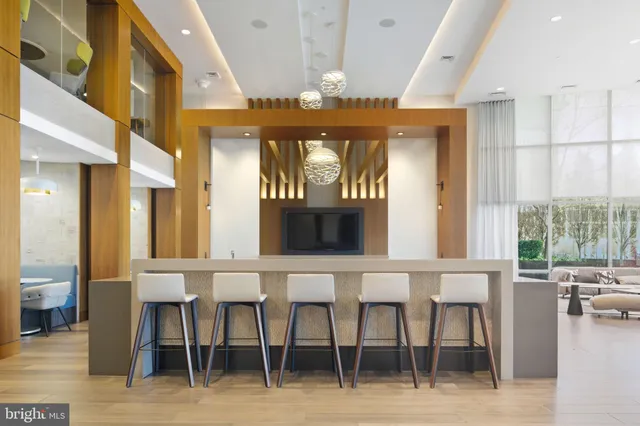 a view of a room with lots of furniture and windows