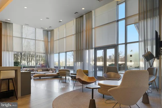 a living room with fireplace furniture and a large window