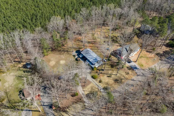 an aerial view of a house with a yard basket ball court and outdoor seating