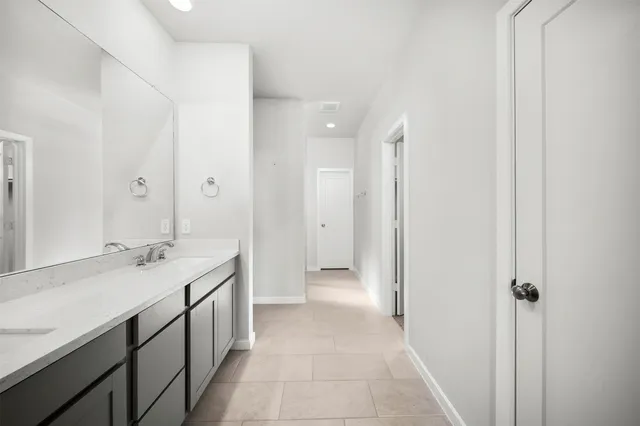 a bathroom with a double vanity sink and a mirror